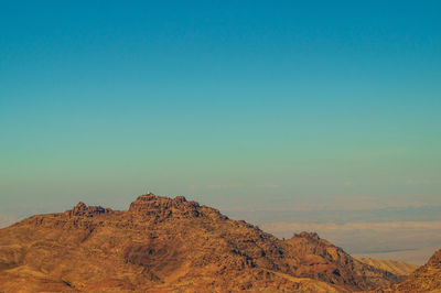 Scenic view of mountains against clear blue sky