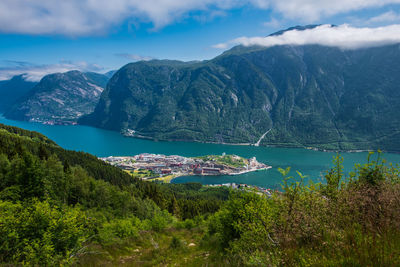 Scenic view of sea and mountains against sky