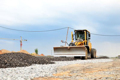 Construction site on road against sky