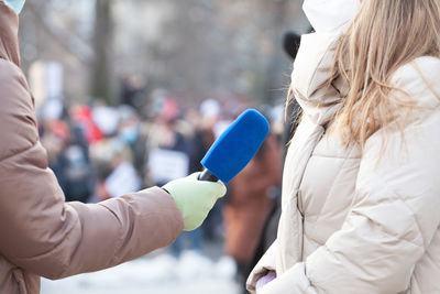 Midsection of woman holding umbrella