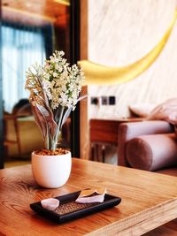 Close-up of flower vase on table at home