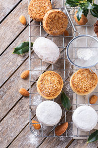 Traditional spanish christmas sweets, shortbread mantecados and polvorones on a wooden table