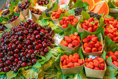 Cherries and strawberries for sale at a market stall