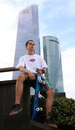 Low angle view of man against building in city