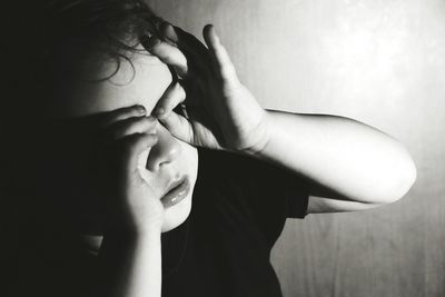 Close-up of boy looking through hand mask