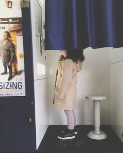 Full length of girl standing in corridor