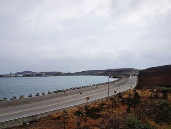 View of beach against cloudy sky