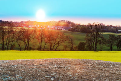 Scenic view of field against sky during sunset