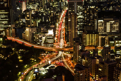 High angle view of city lit up at night