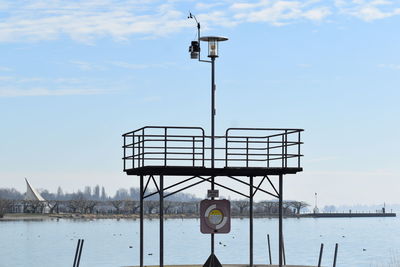 Lifeguard hut by sea against sky