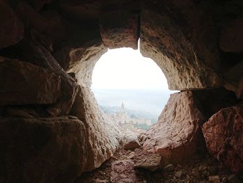 Scenic view of cave seen through arch window