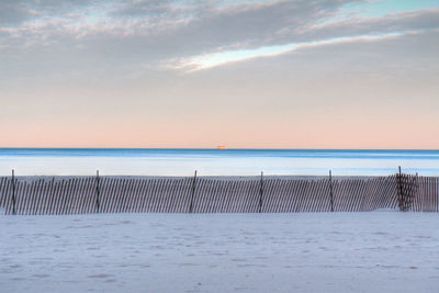 Scenic view of beach against sky during sunset