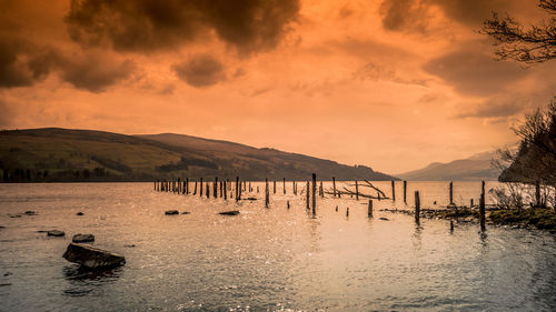 Scenic view of lake against sky during sunset