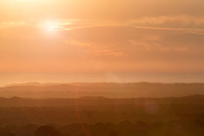 Scenic view of landscape against sky during sunset