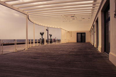 Promenade by sea against sky