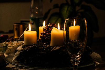 Glowing candles in darkroom during christmas