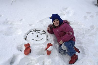 High angle portrait of cute girl playing in snow