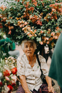 Portrait of woman with red flowers