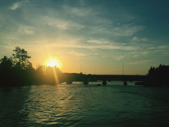 Scenic view of river against sky during sunset