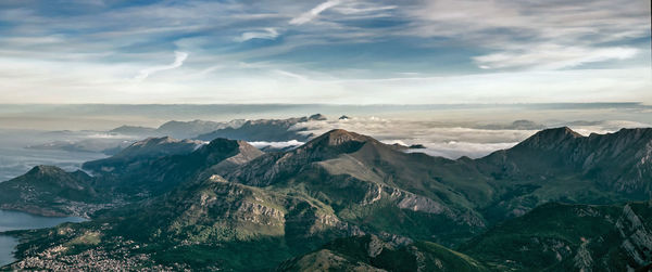 Scenic view of mountain ranges against cloudy sky