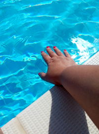Low section of woman swimming in pool