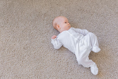 High angle view of baby girl lying on floor