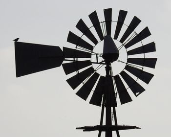 Low angle view of traditional windmill against clear sky