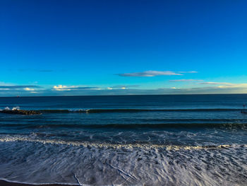 Scenic view of sea against blue sky