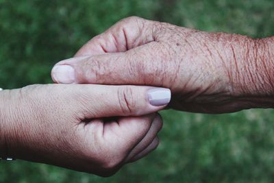 Cropped hands touching outdoors