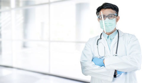 Portrait of female doctor standing in bathroom