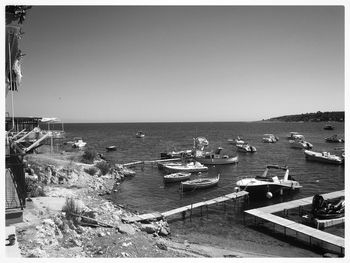 High angle view of boats moored in sea against clear sky