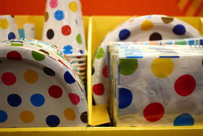 Paper plates and tissue papers with polka dots for sale in store