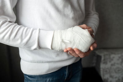 The broken hand of a man in a cast