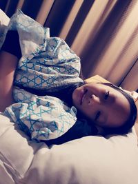 Portrait of woman lying on bed