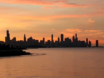 Scenic view of buildings against sky during sunset