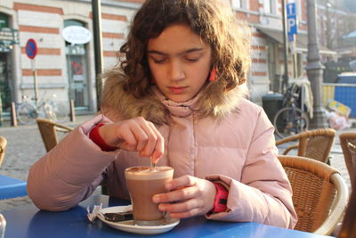 Young girl drinking hot chocolate in winter