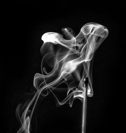 Close-up of smoke over black background