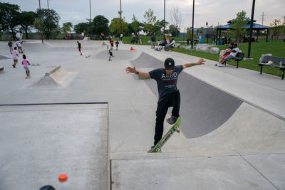 Group of people skateboarding on road