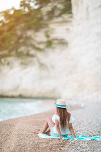 Woman sitting on chair at beach