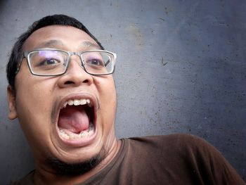 Portrait of man wearing mask against wall