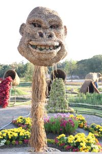 Portrait of statue against plants