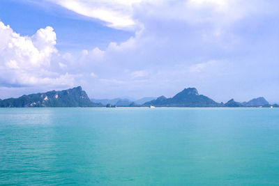 Scenic view of sea and mountains against sky