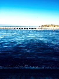 Scenic view of sea against clear blue sky