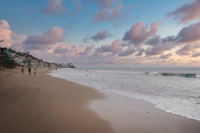 Scenic view of beach against sky during sunset