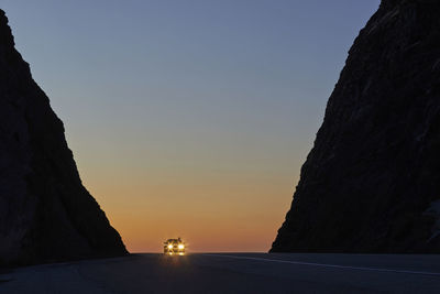 Car on road at sunset