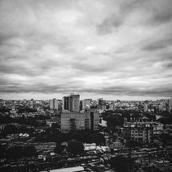 Cityscape against cloudy sky