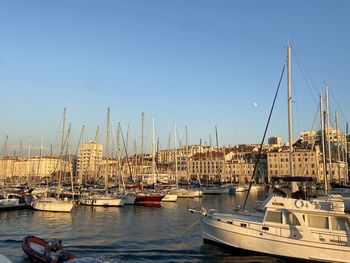 Boats in the vieux port of marseille against clear blue sky