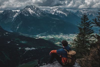 Rear view of men sitting on mountain