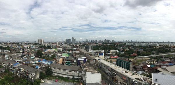 High angle view of cityscape against cloudy sky