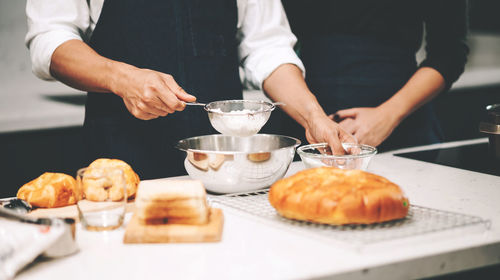 Midsection of man preparing food on table